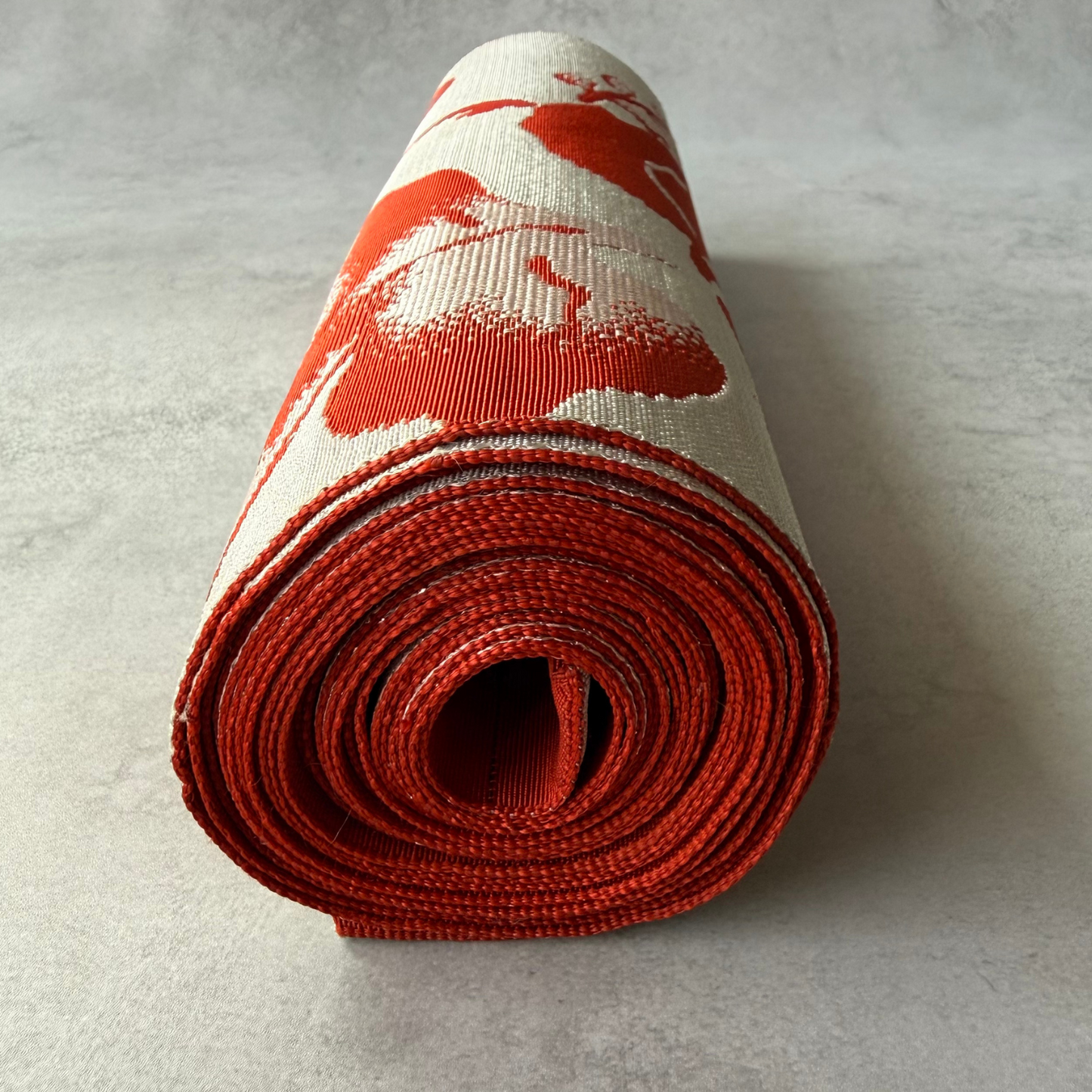 End view of antique Japanese ivy leaf obi fabric roll