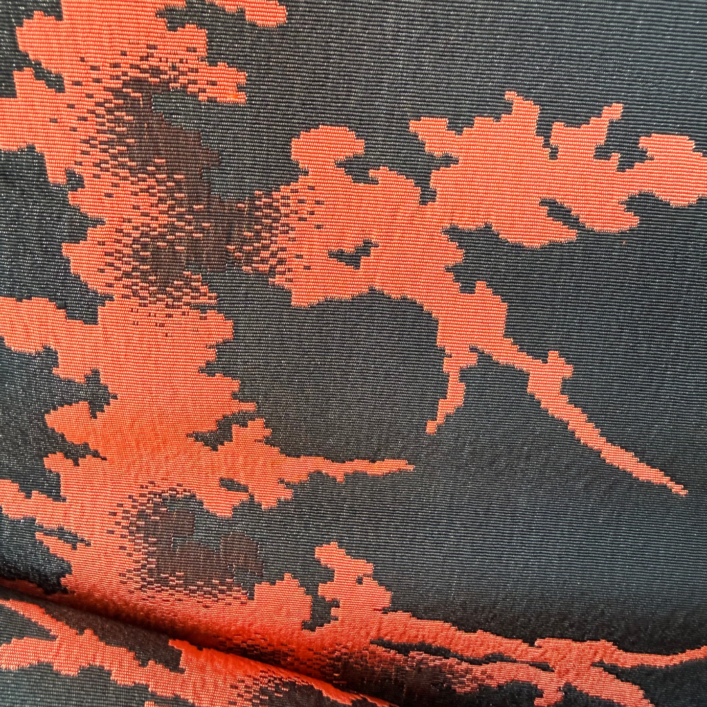 Texture detail of black coral and brown abstract rayon obi weaving