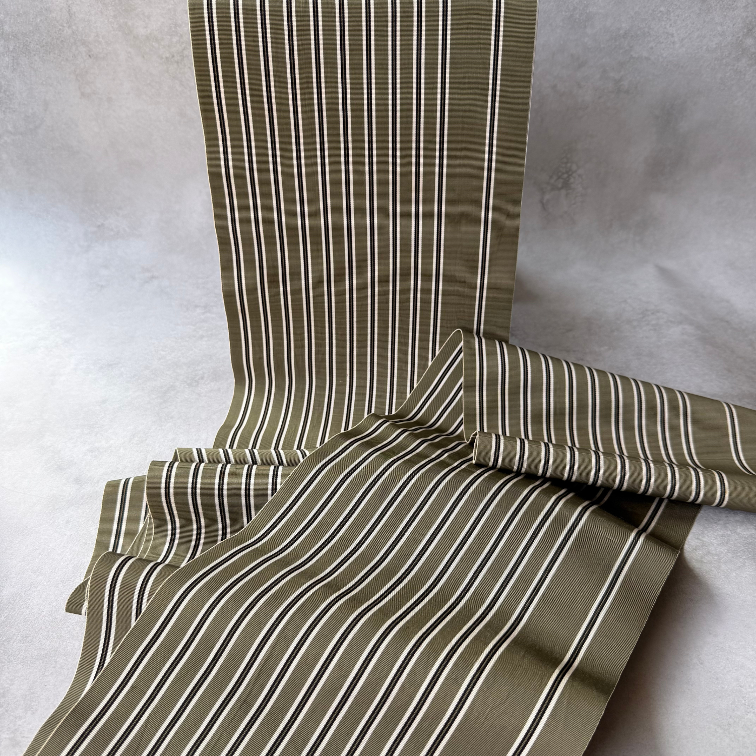 Japanese olive striped obi textile draped to show pattern and texture