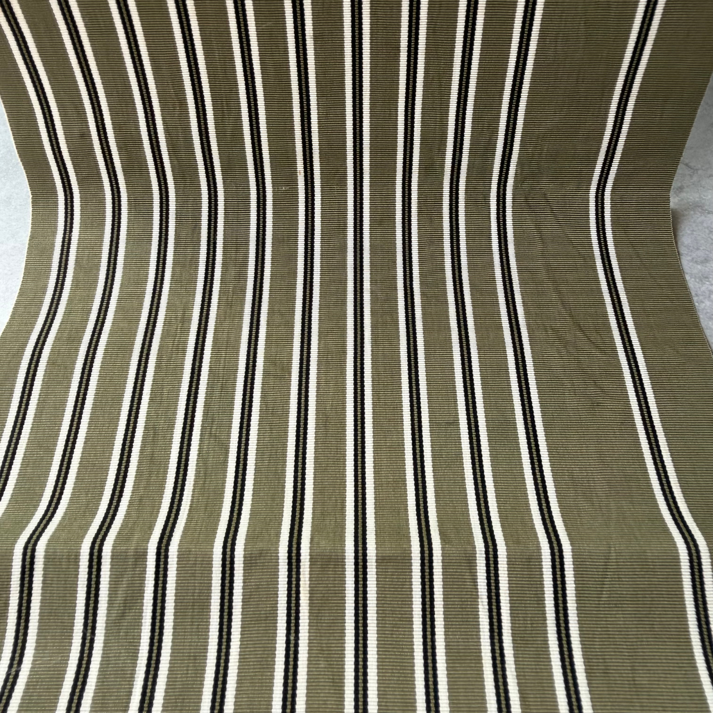 Close-up of olive green black and ivory striped rayon obi fabric