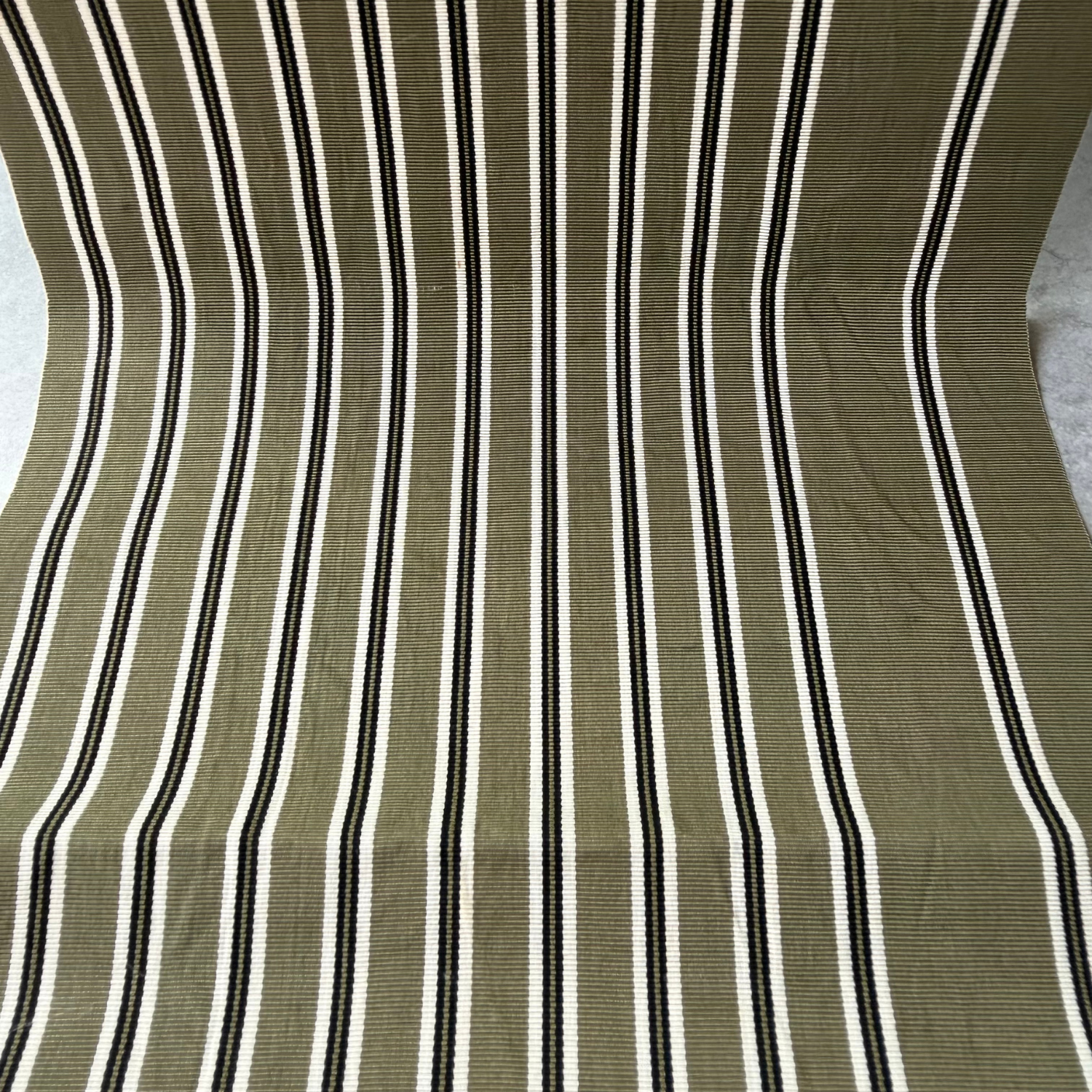 Close-up of olive green black and ivory striped rayon obi fabric