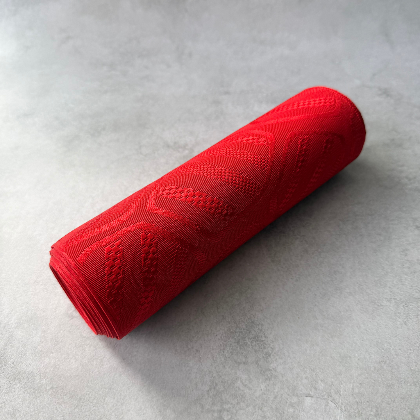 Rolled Japanese red obi fabric bolt for sewing and textile crafts