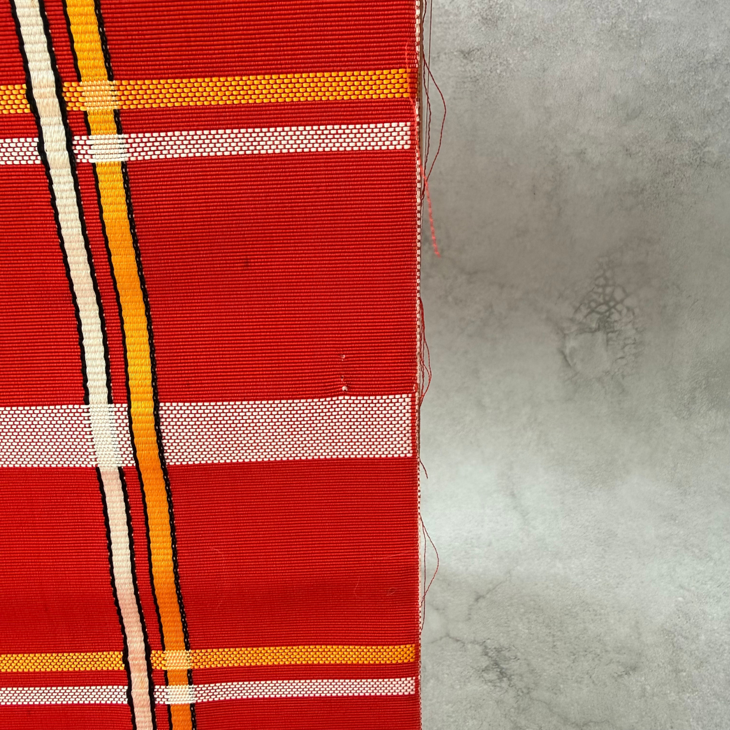 Condition detail showing wear on pre-owned red obi fabric