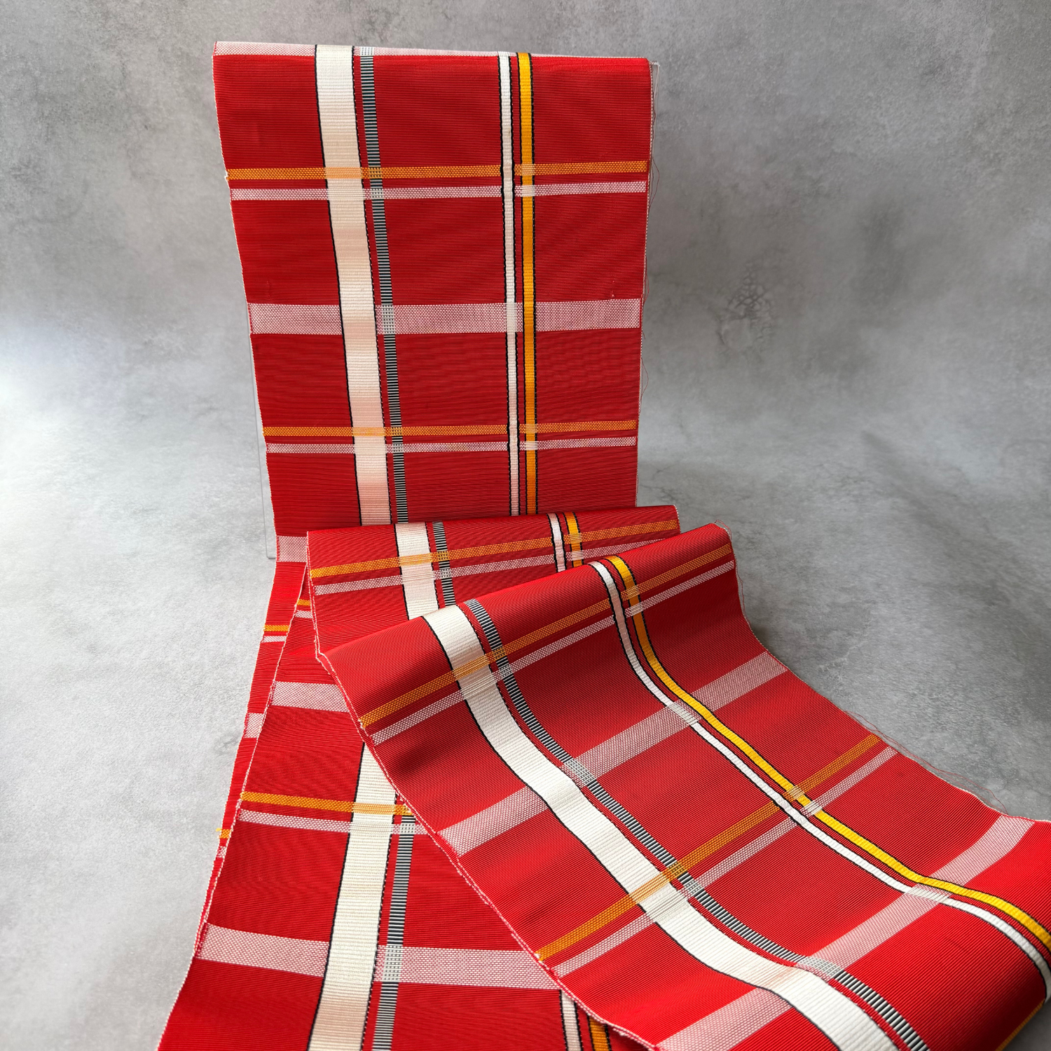 Red rayon obi fabric with white black and yellow woven stripes