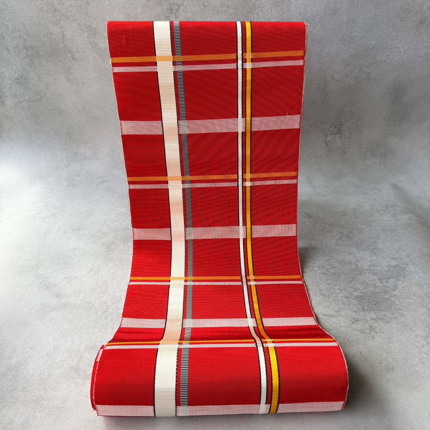 Pre-owned Japanese red plaid obi fabric bolt shown unrolled
