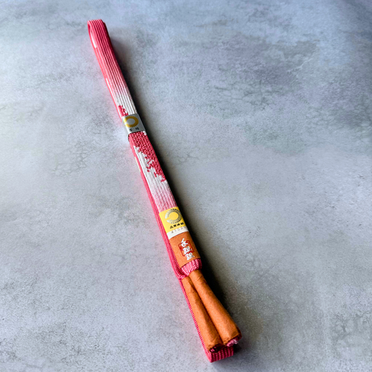 Unused Japanese hand-braided silk Korai-gumi obijime in coral pink, white and red, folded full view