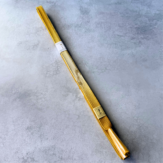 Full view of an unused Japanese silk Korai-gumi obijime cord in golden ochre and metallic gold