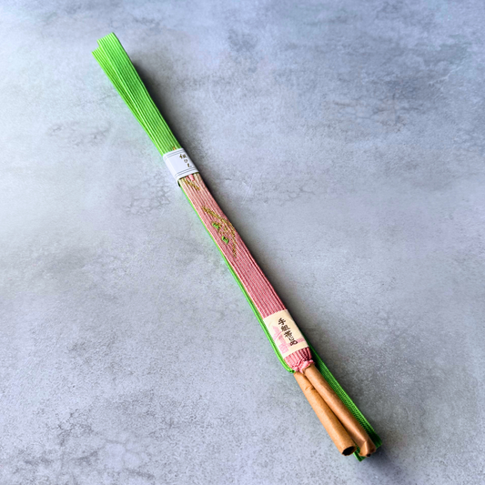Japanese hand-braided silk Korai-gumi obijime in vivid spring green and blush pink, full view