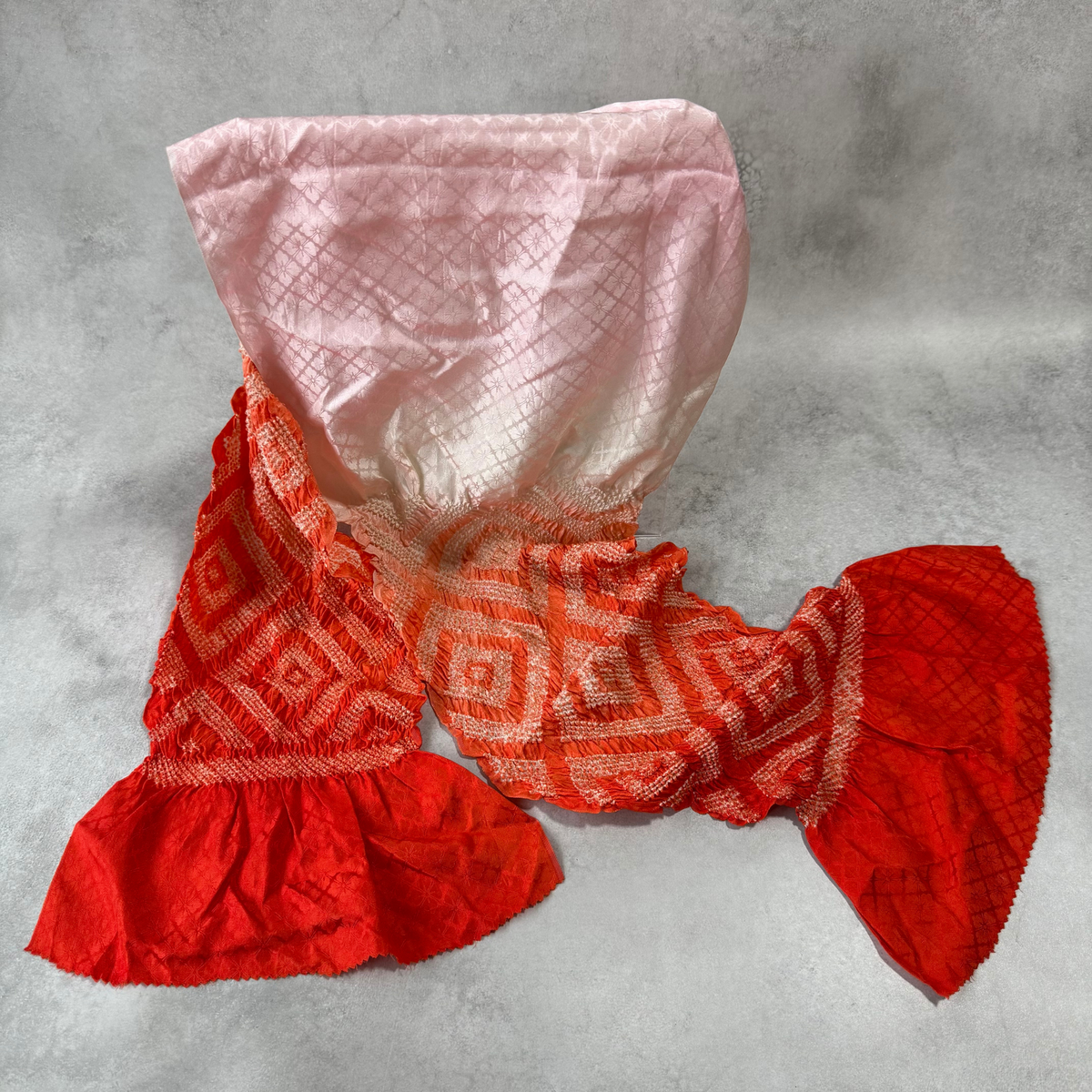 Japanese silk shibori obiage in vermilion red and pale pink, full view