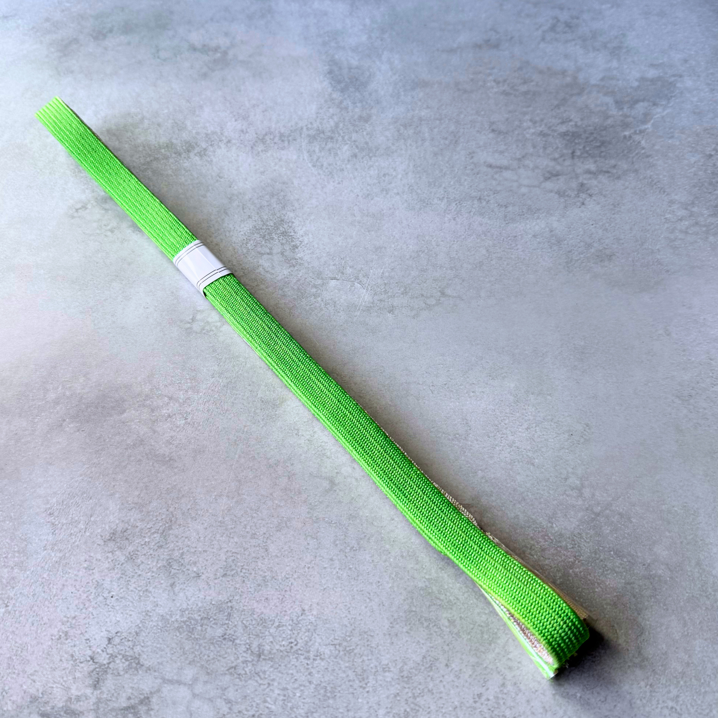 Plain vivid lime green side of the hand-braided Japanese silk obijime