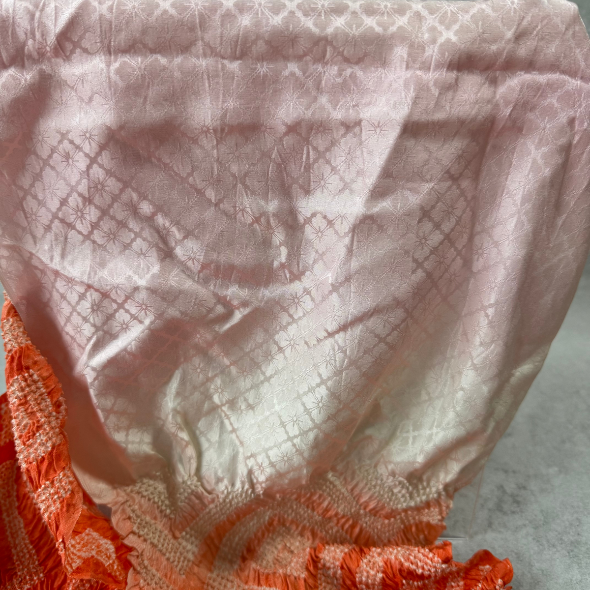 Close-up of pale pink silk obiage with woven floral jacquard pattern