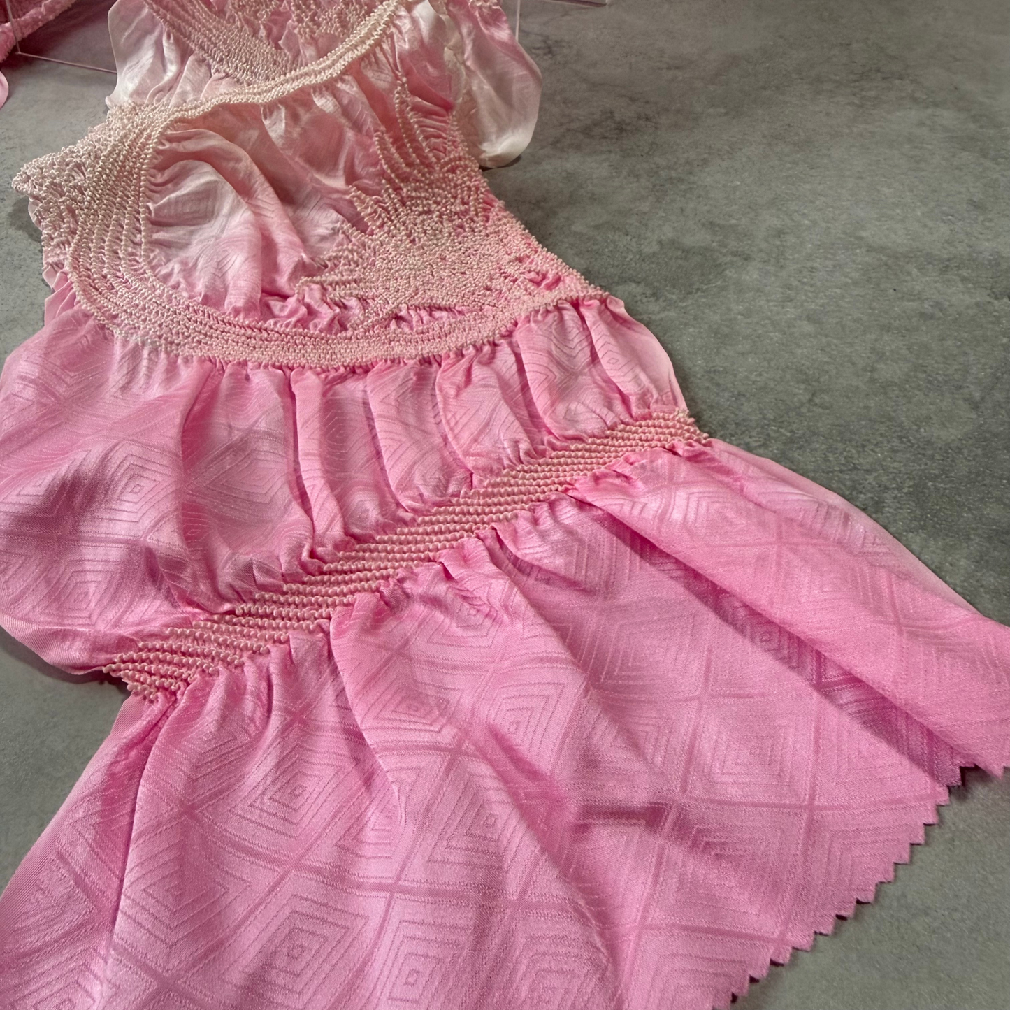 Detail of the lustrous pink silk and geometric jacquard pattern on a vintage obiage