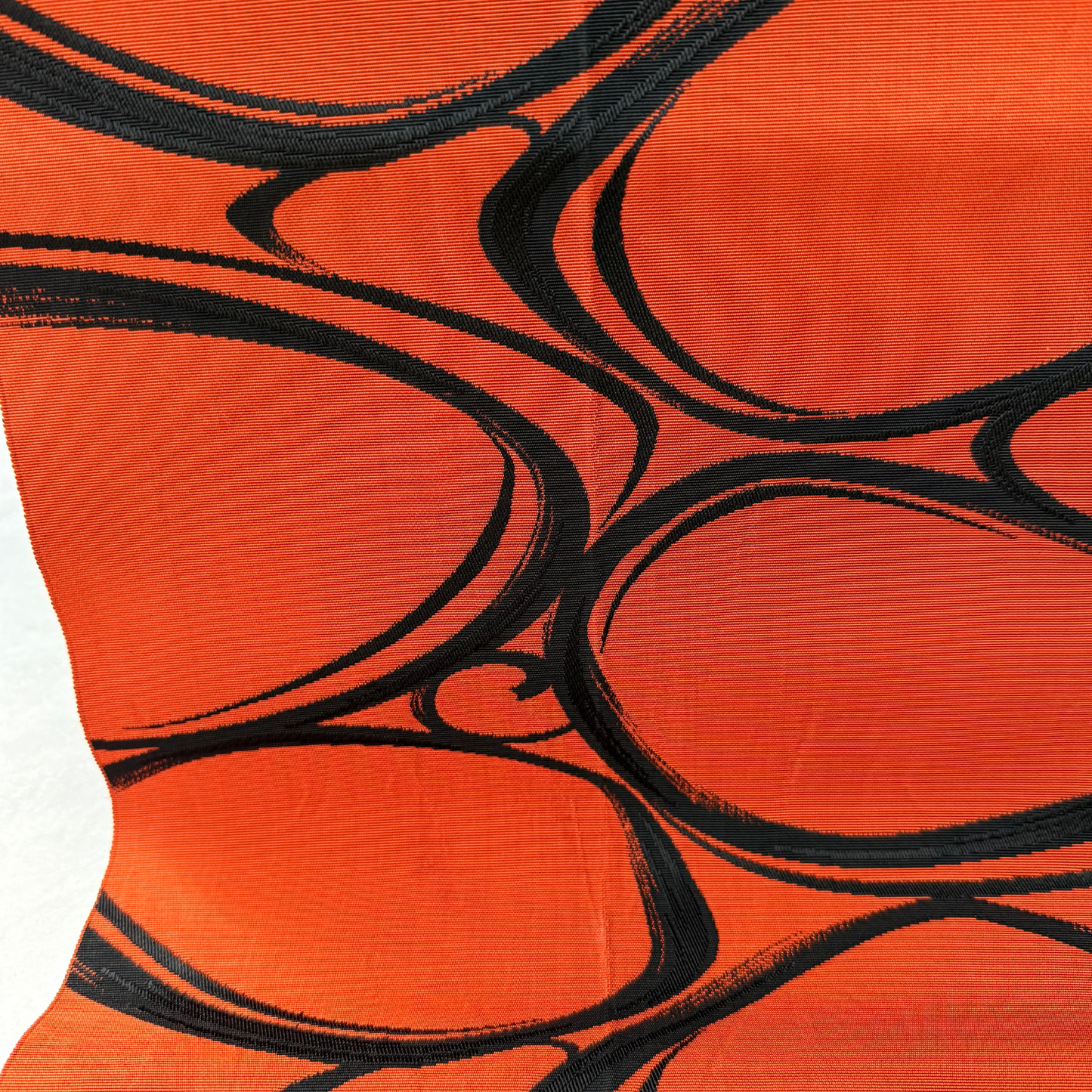 Close-up of brown and black flowing water woven pattern