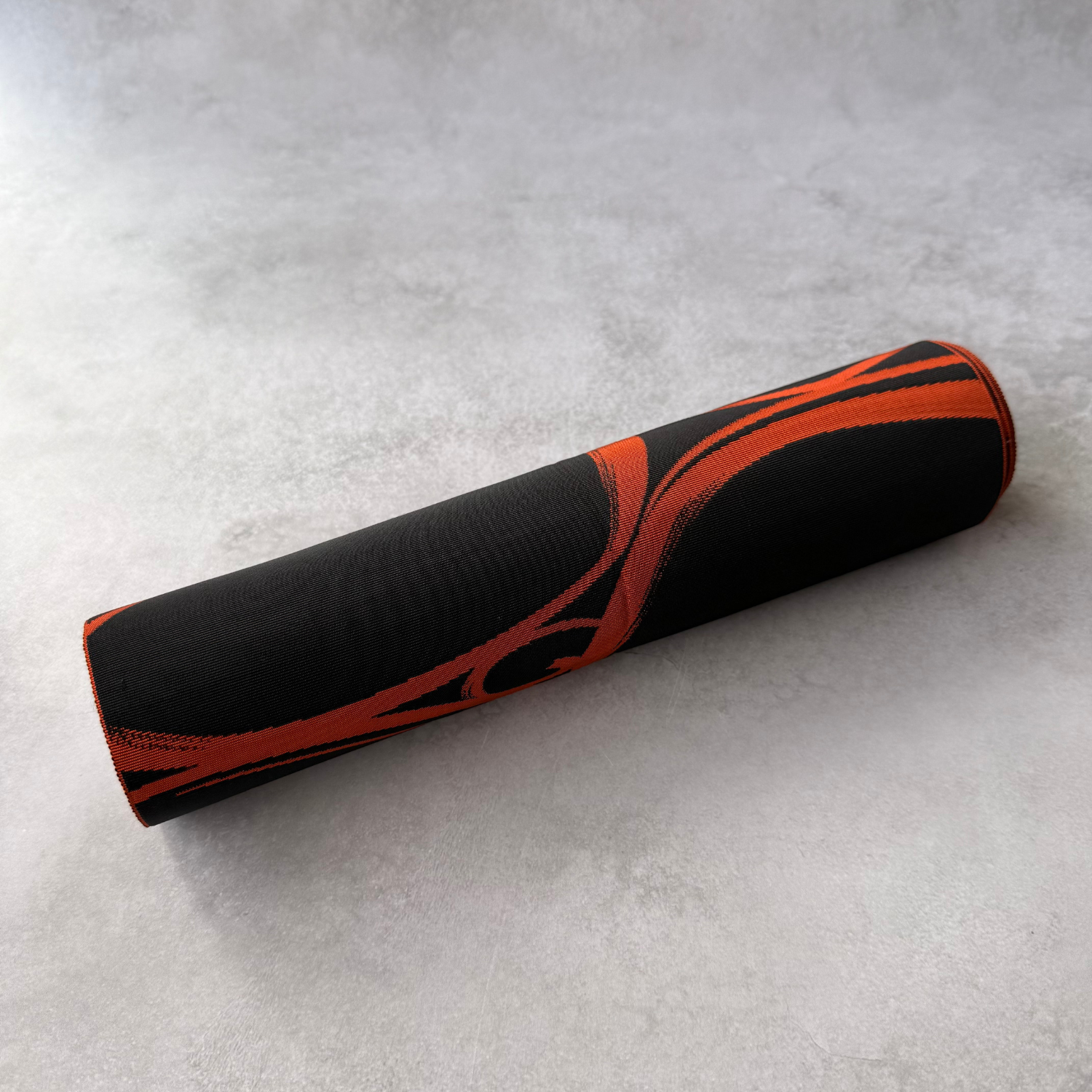Rolled view of brown and black hachisun obi fabric