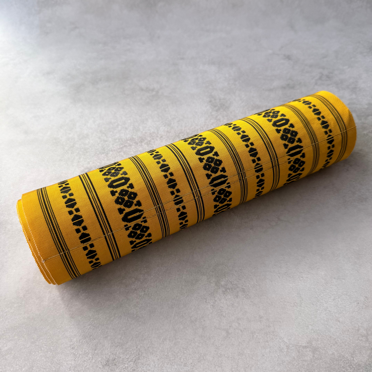 Rolled view of antique Japanese striped obi fabric