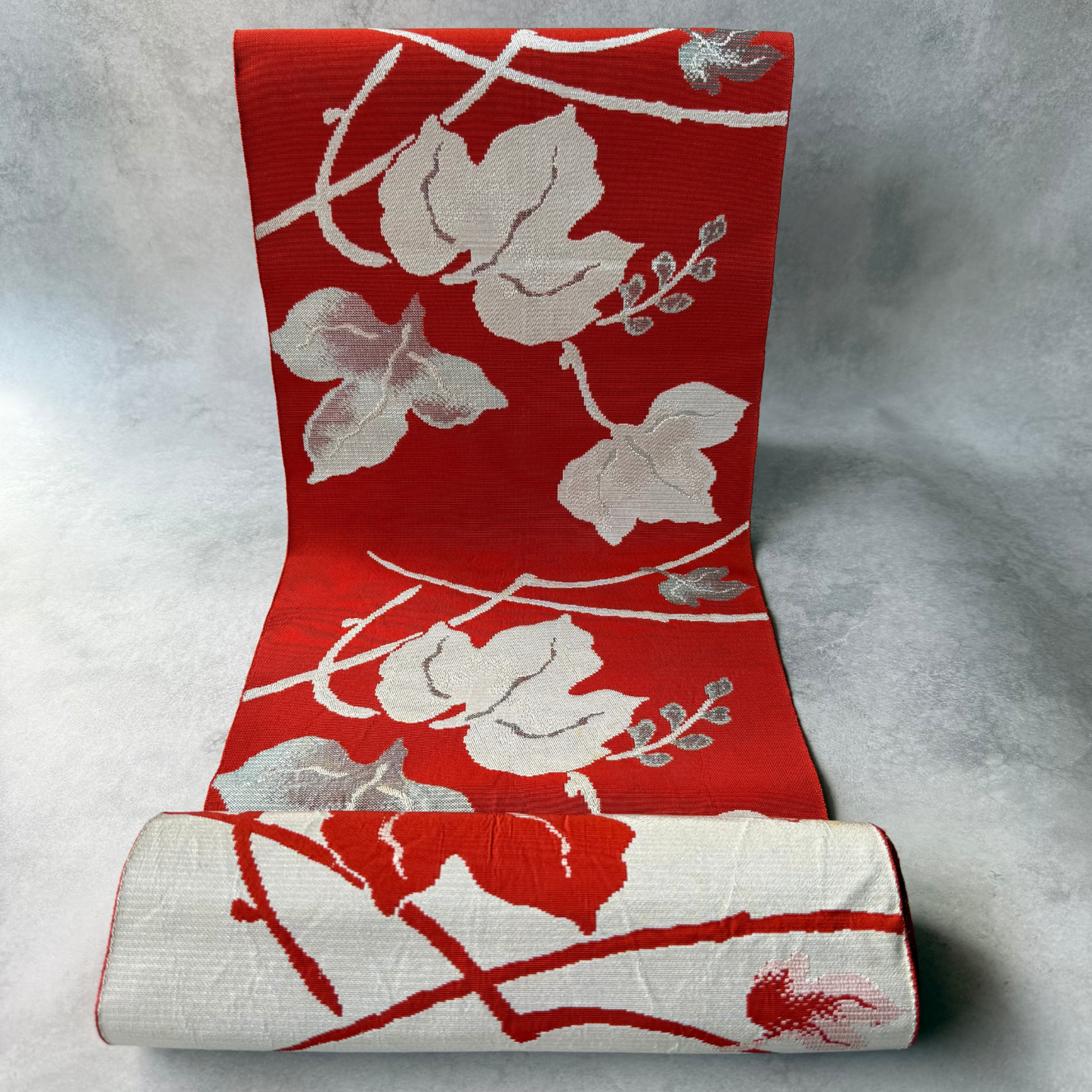 Antique reddish brown Japanese hachisun obi fabric with woven ivy leaf pattern