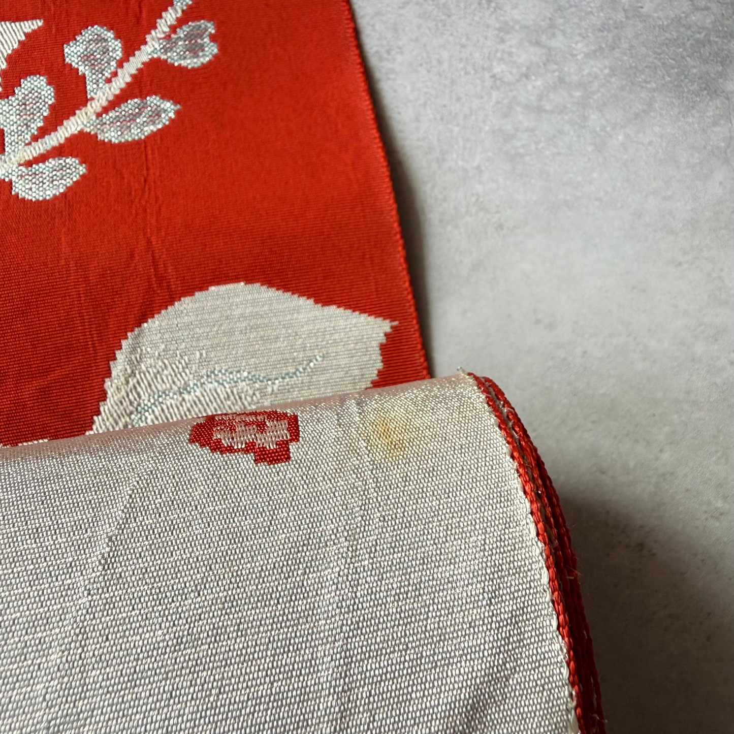 Close-up showing age-related stains on antique obi textile