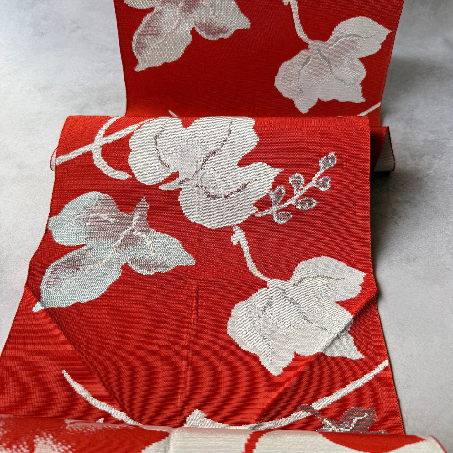 Draped antique Japanese obi fabric with large ivy leaf motifs