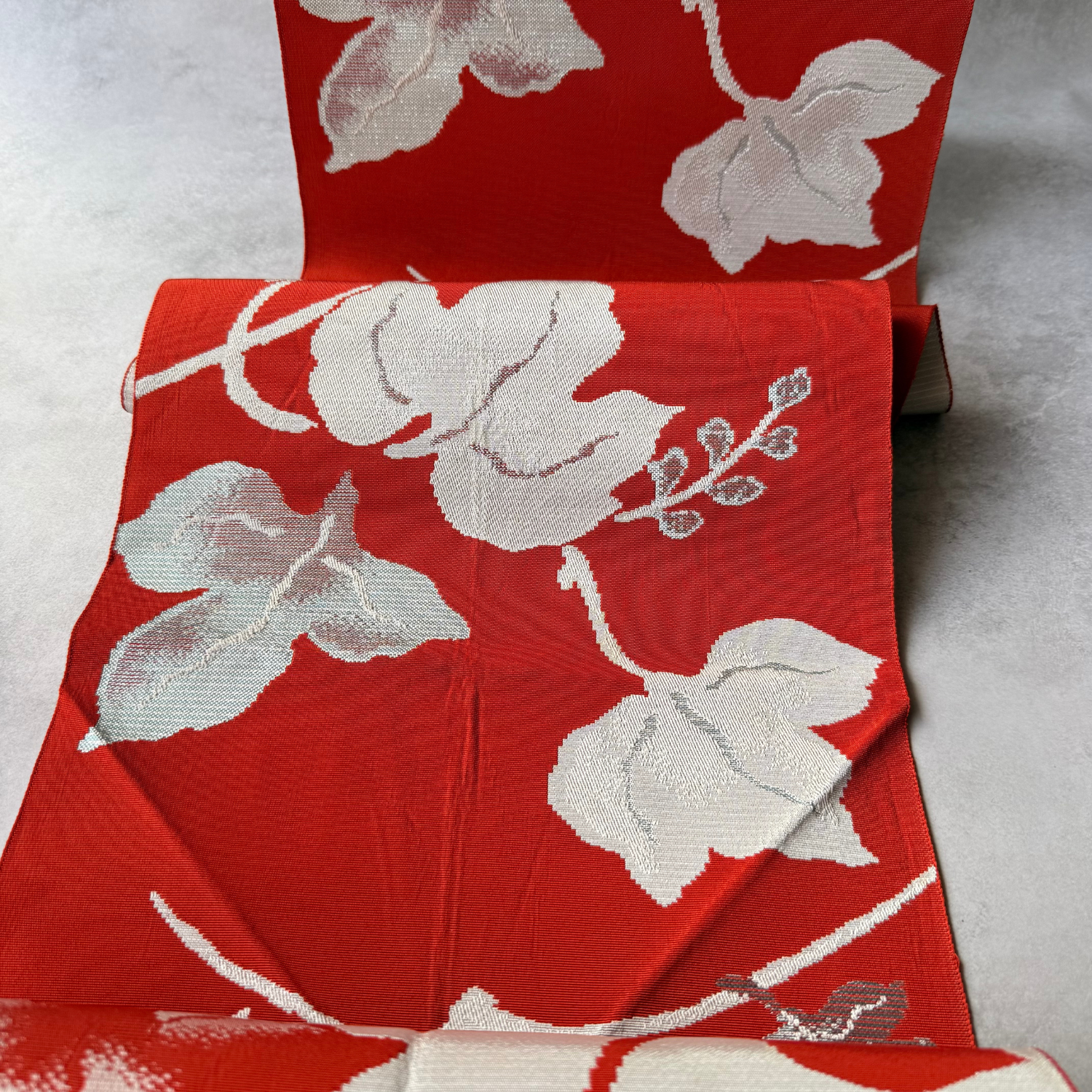 Draped antique Japanese obi fabric with large ivy leaf motifs