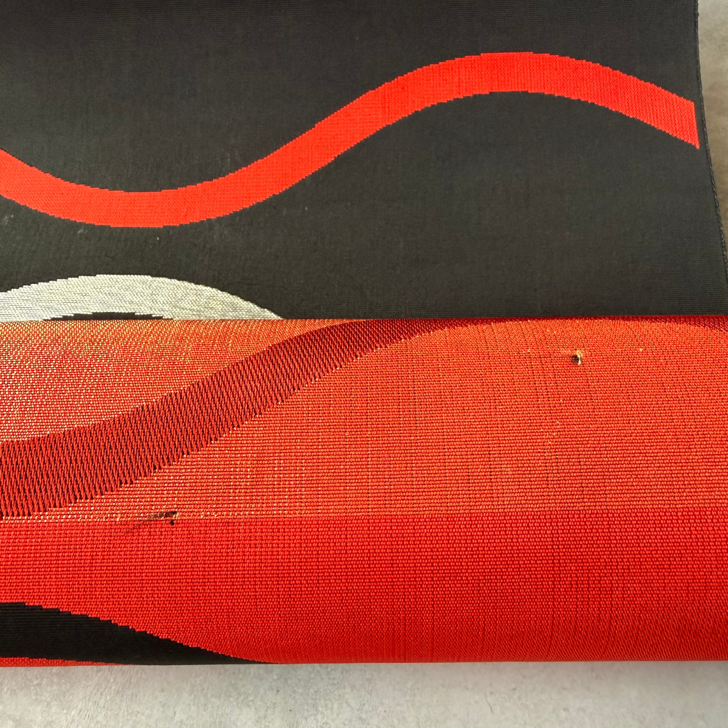Condition detail of black and red antique Japanese obi textile