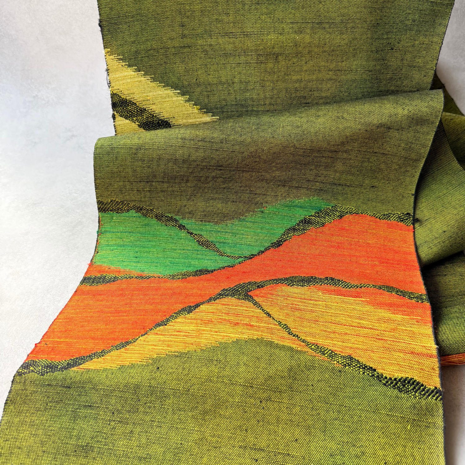 Close view of layered mountain design on Japanese silk obi fabric