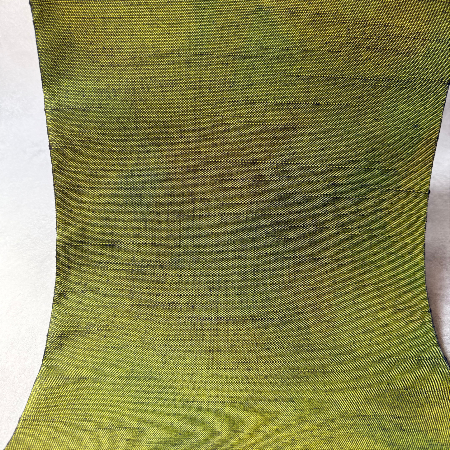 Texture detail of dark matcha green handwoven tsumugi silk