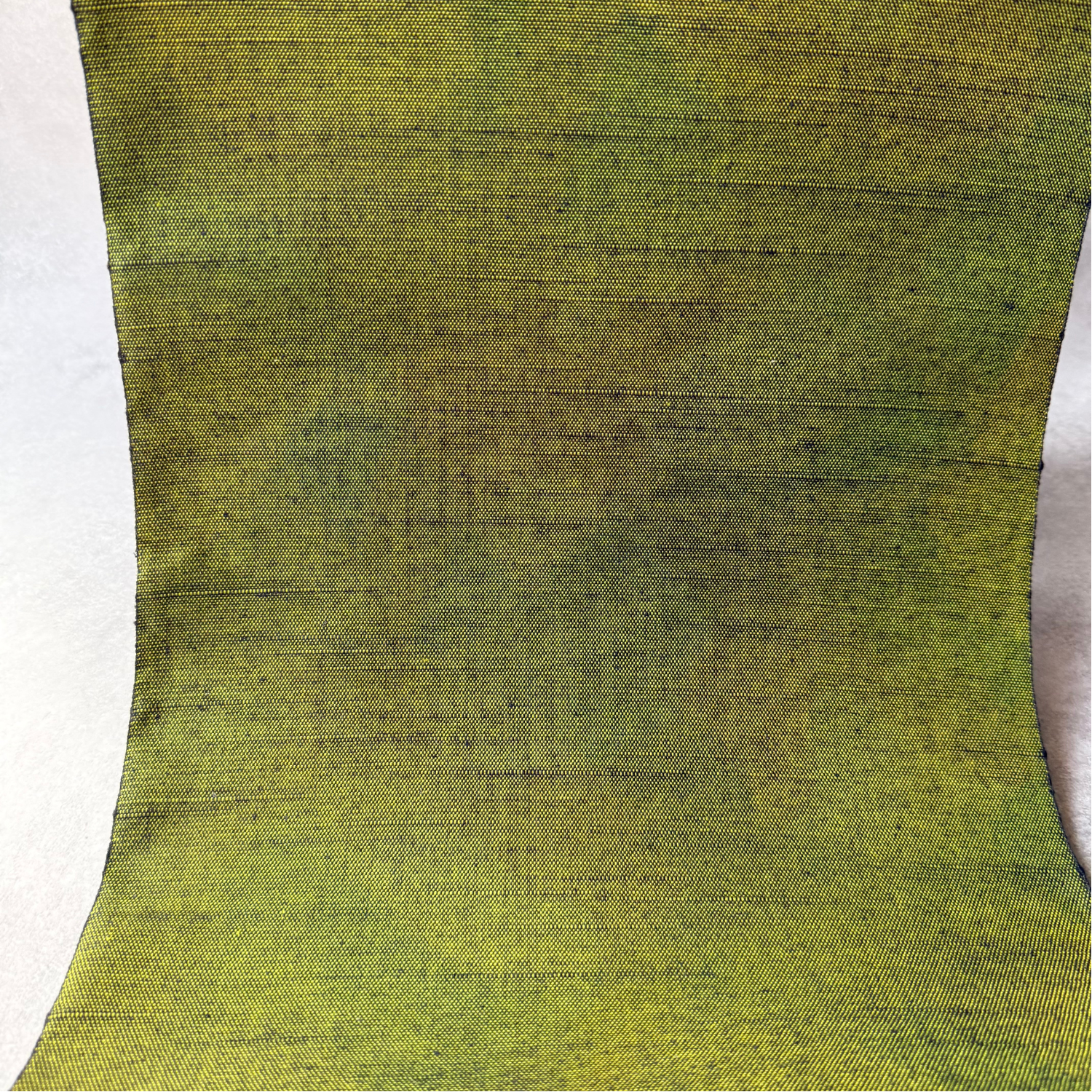 Texture detail of dark matcha green handwoven tsumugi silk