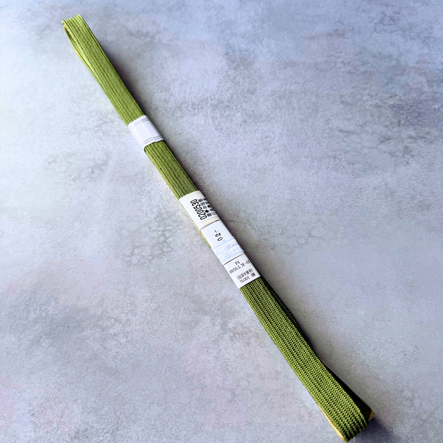 Plain olive green reverse side and original labels of unused silk obijime