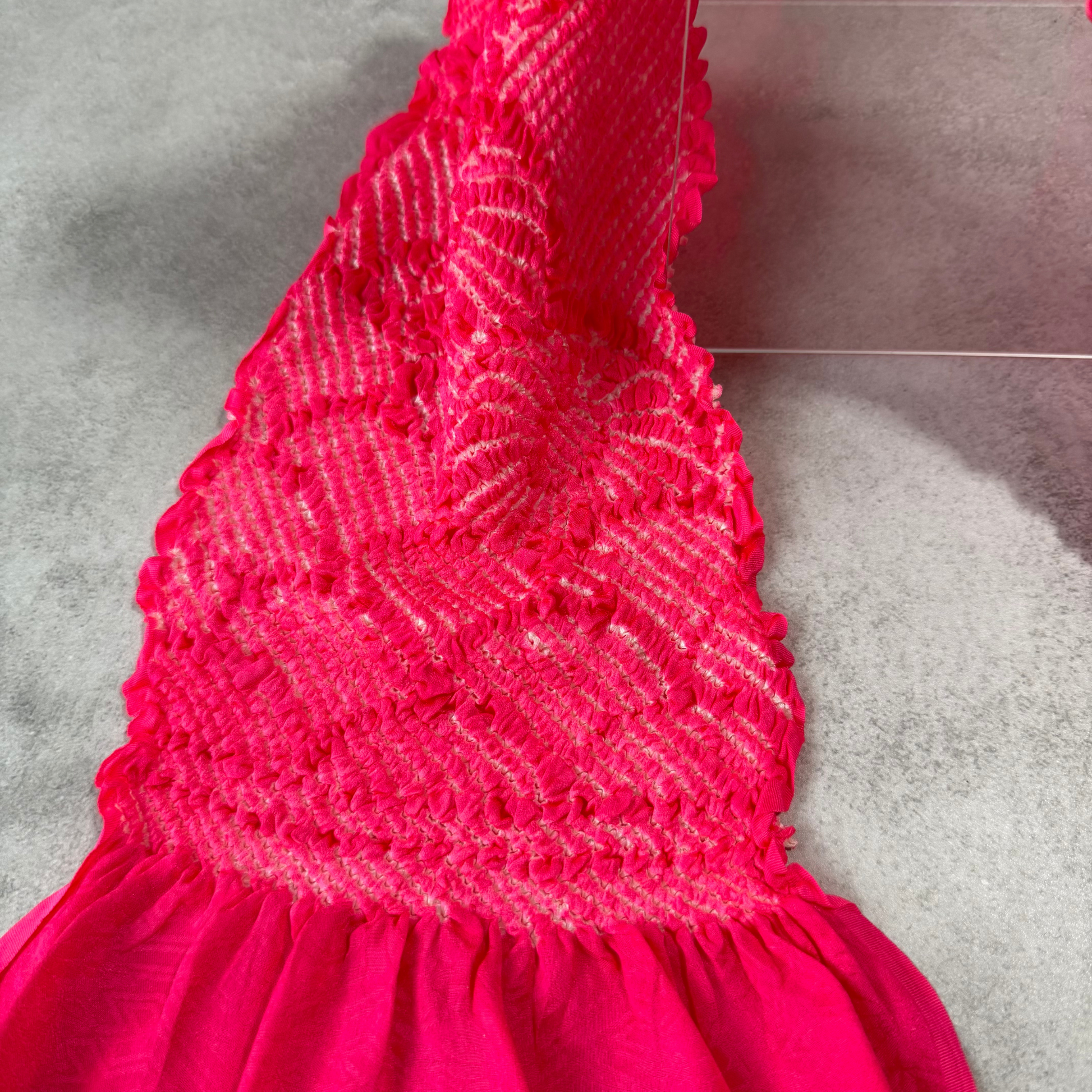 Detailed view of the textured white shibori work on vivid pink Japanese silk